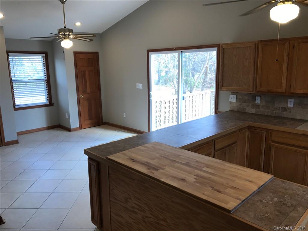 1221 Gold Hill Road Fort Mill, SC 29708 - Photo 13 of 32 a kitchen with a wooden floor and a window