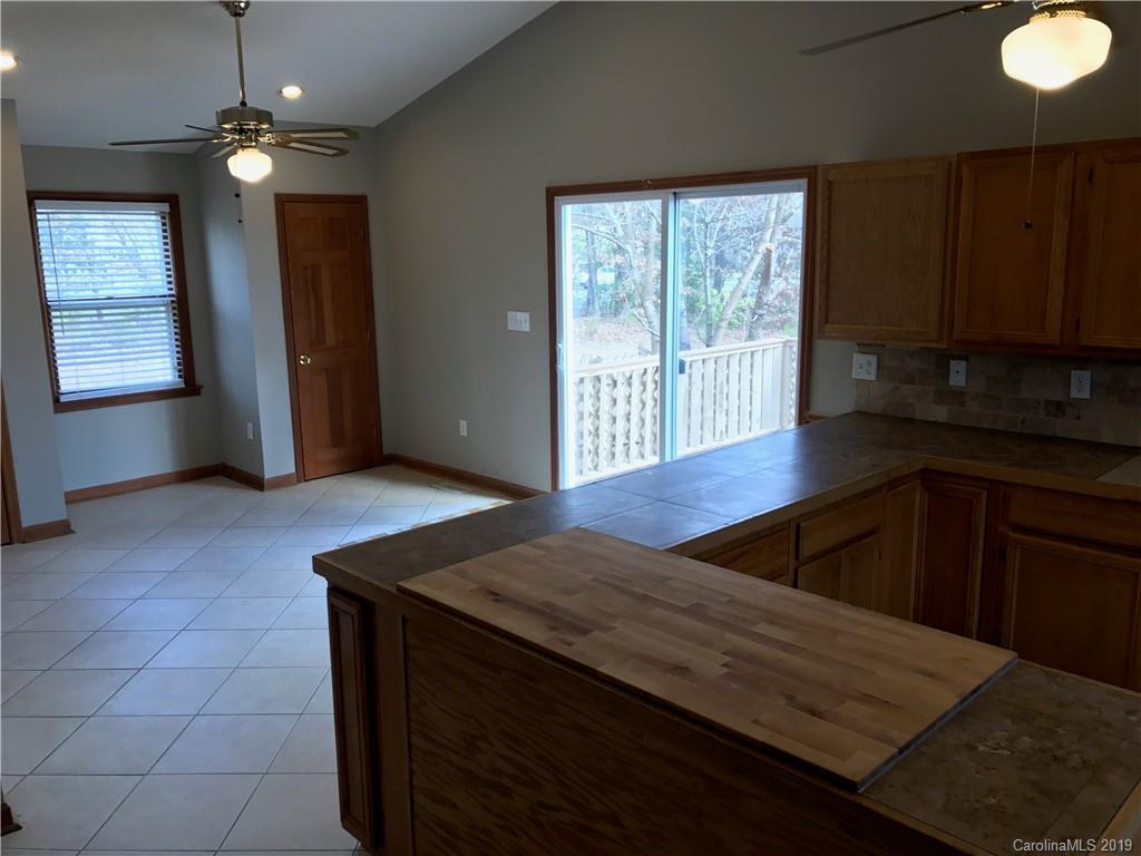 1221 Gold Hill Road Fort Mill, SC 29708 - Photo 14 of 32 a kitchen with stainless steel appliances granite countertop a sink window and cabinets
