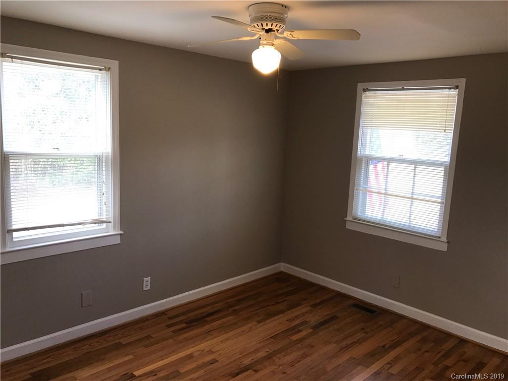 1221 Gold Hill Road Fort Mill, SC 29708 - Photo 19 of 32 a view of an empty room with wooden floor and a window