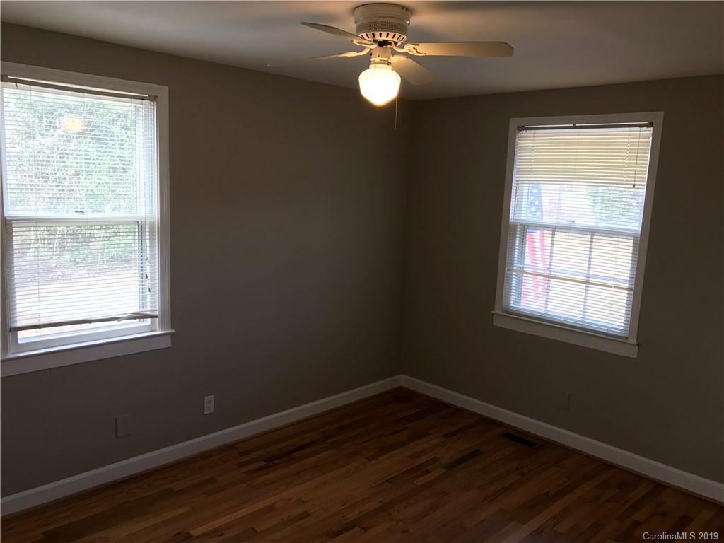 1221 Gold Hill Road Fort Mill, SC 29708 - Photo 20 of 32 a view of an empty room with wooden floor and a window