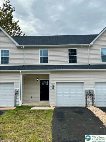 a front view of a house with a garage