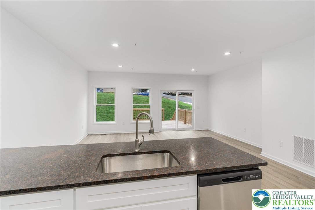 306 Barber Street, Unit LOT 39 Allentown, PA 18103 - Photo 12 of 30 a kitchen with granite countertop a sink and a window