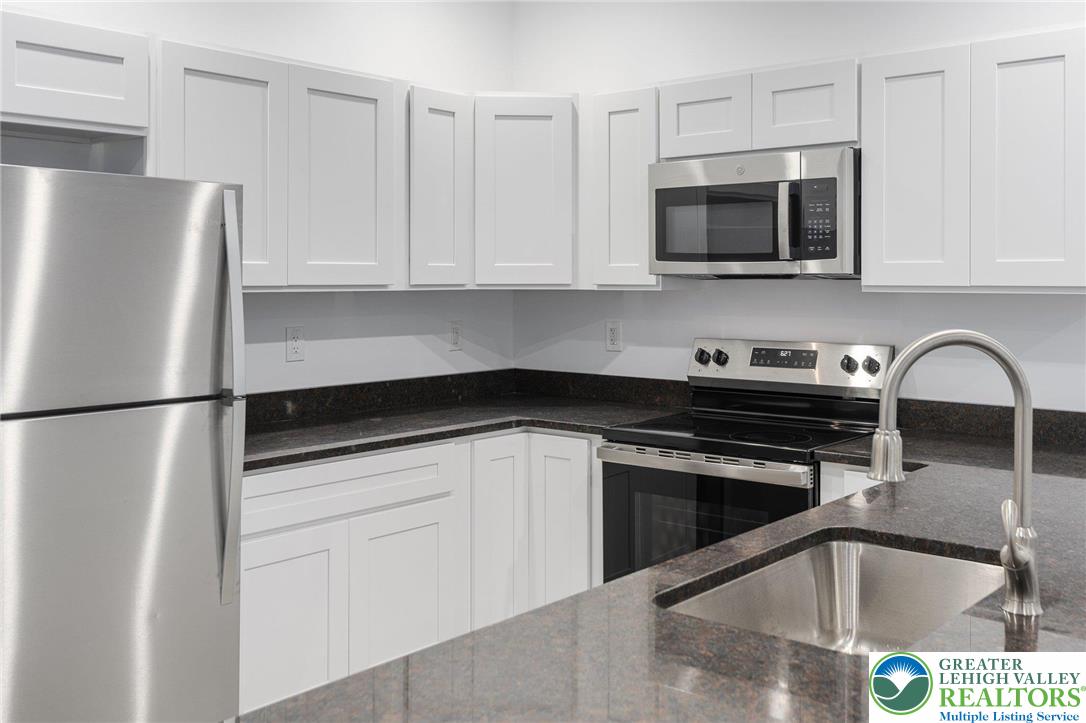 306 Barber Street, Unit LOT 39 Allentown, PA 18103 - Photo 16 of 30 a kitchen with stainless steel appliances a refrigerator sink and microwave