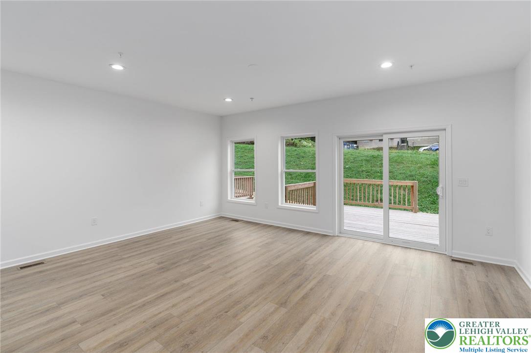 306 Barber Street, Unit LOT 39 Allentown, PA 18103 - Photo 10 of 30 a view of an empty room with wooden floor and a window