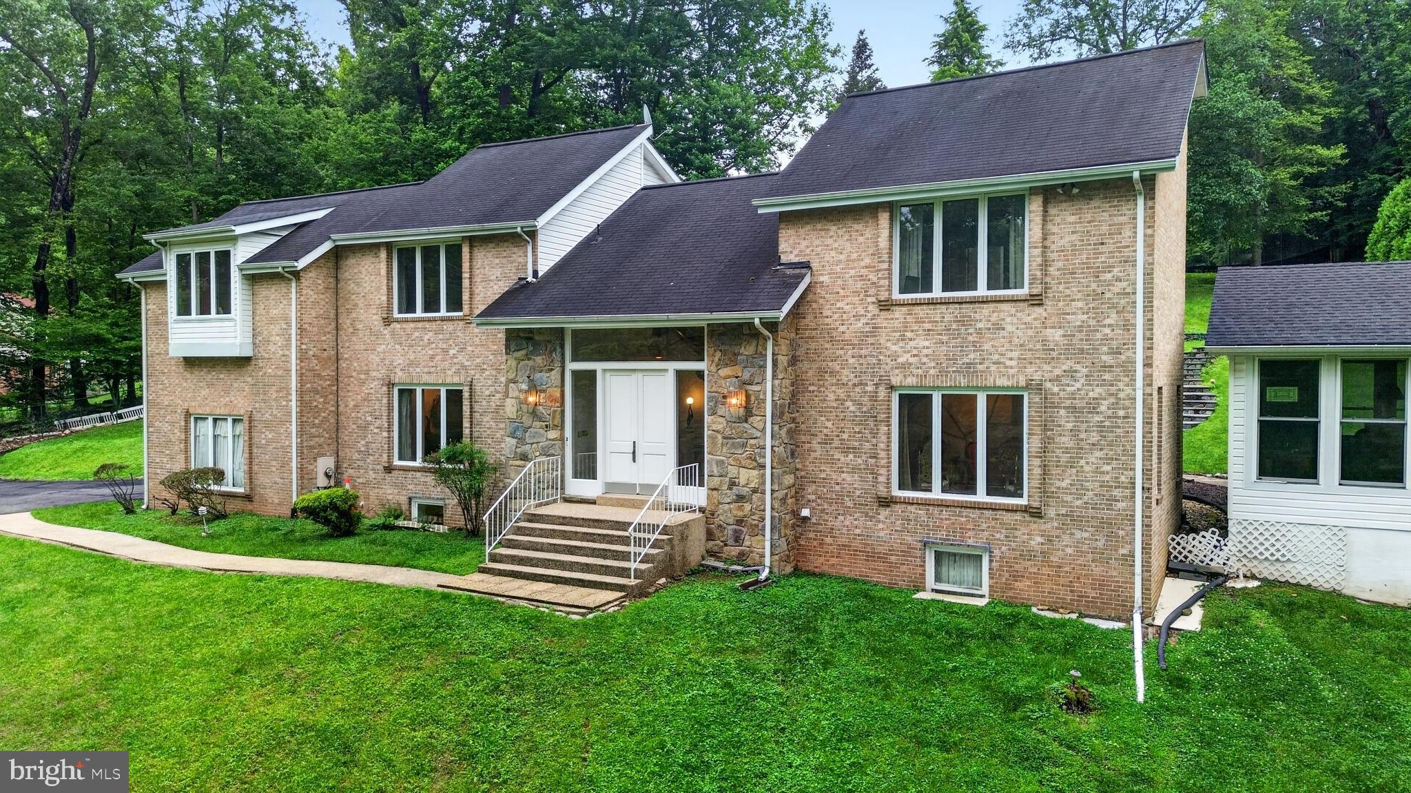 10320 Glen Road Potomac, MD 20854 - Photo 64 of 75 a front view of a house with a garden