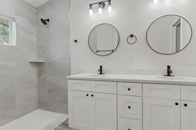 a spacious bathroom with a sink and a mirror