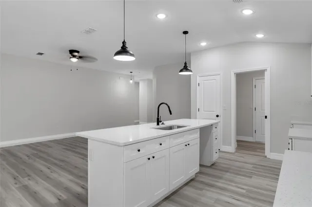 a kitchen with a sink a stove and cabinets