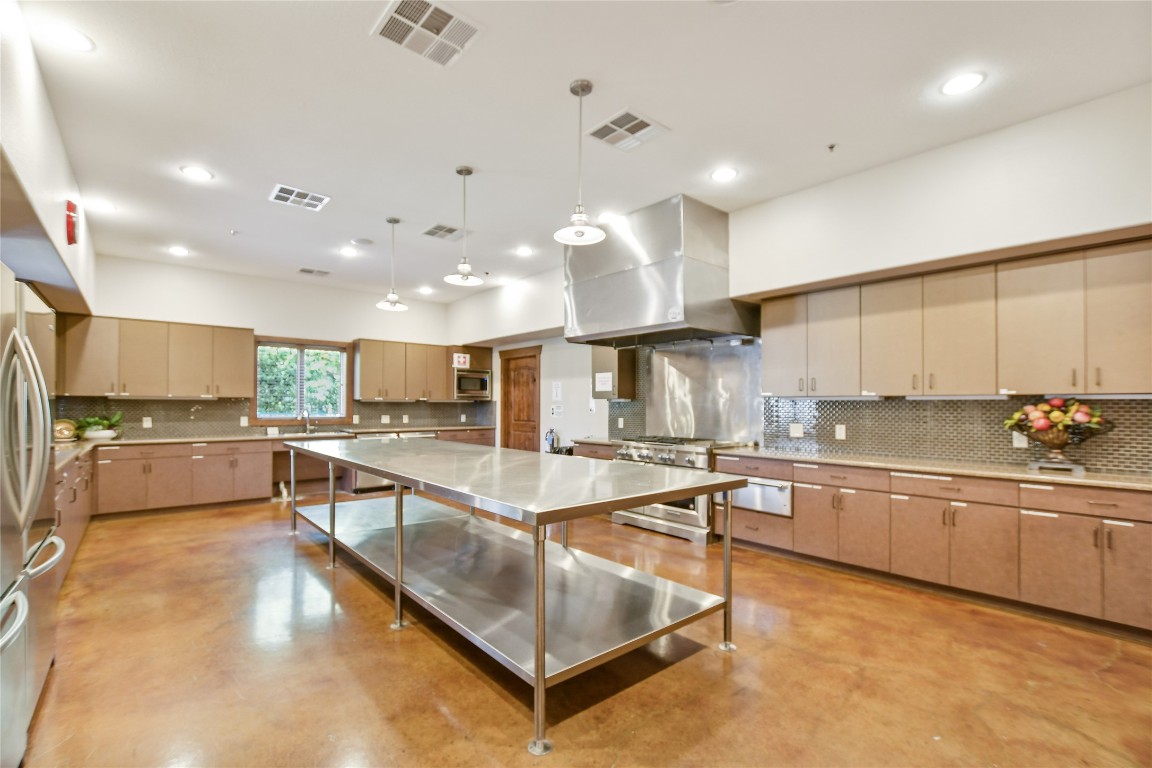 1005 Fort Davis Street Georgetown, TX 78633 - Photo 33 of 38 a large kitchen with a large counter top furniture a stove and a sink