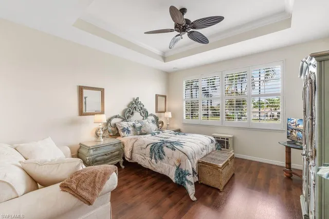 a spacious bedroom with a bed couch and a window