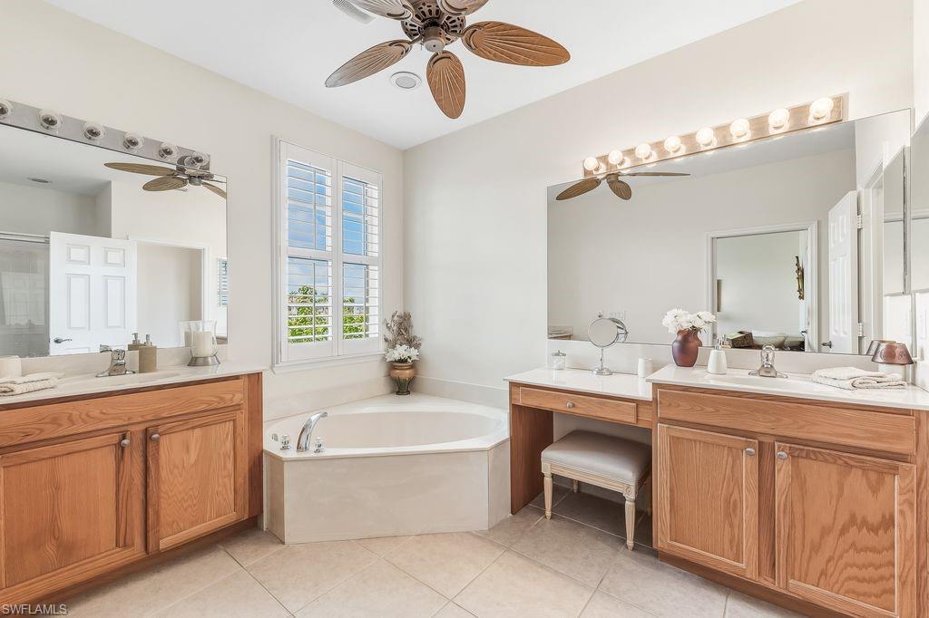 3951 Cherrybrook Loop Fort Myers, FL 33966 - Photo 13 of 34 a spacious bathroom with a double vanity sink mirror and bathtub