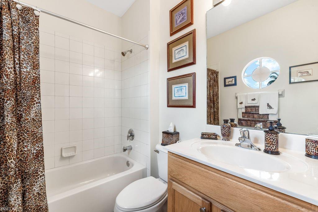 3951 Cherrybrook Loop Fort Myers, FL 33966 - Photo 16 of 34 a bathroom with a granite countertop sink mirror vanity and toilet