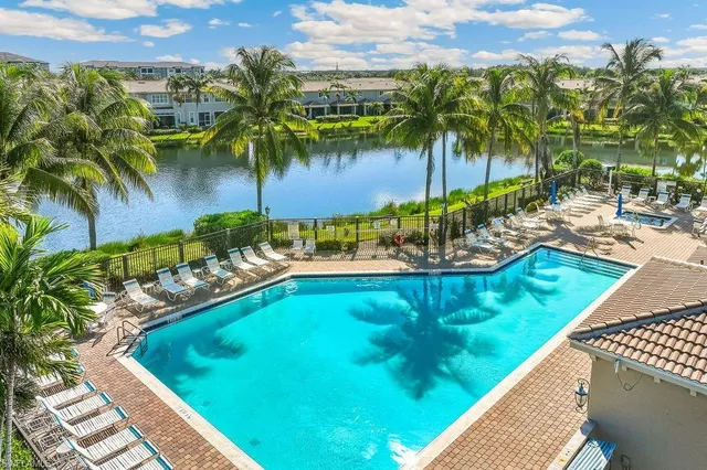 a view of a swimming pool with a lawn chairs and swimming pool