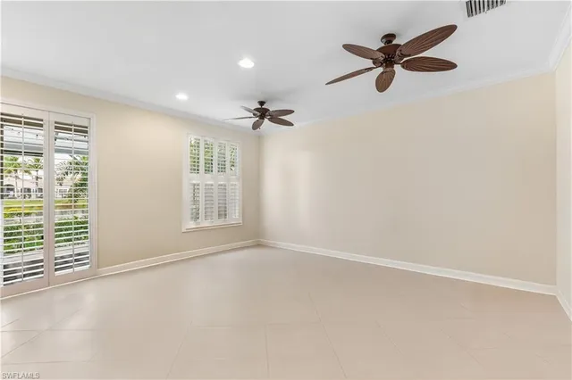 a view of a livingroom with a ceiling fan and window