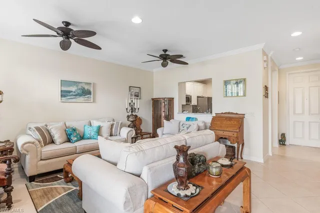 a living room with furniture a ceiling fan and a rug