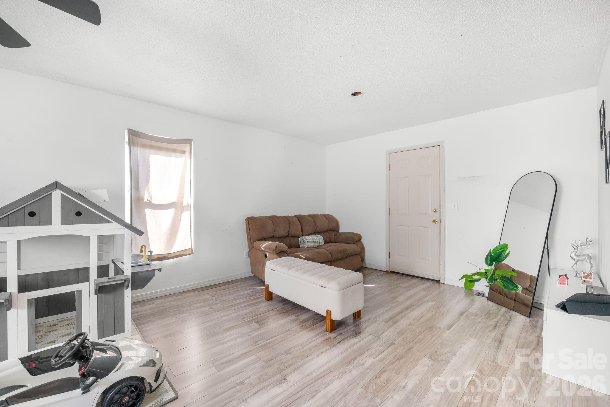 3761 Herman Sipe Road Conover, NC 28613 - Photo 11 of 27 a living room with furniture and a wooden floor