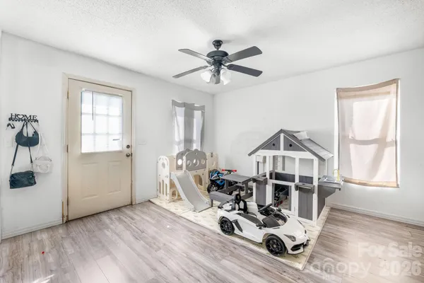 a view of a livingroom with furniture and hardwood floor