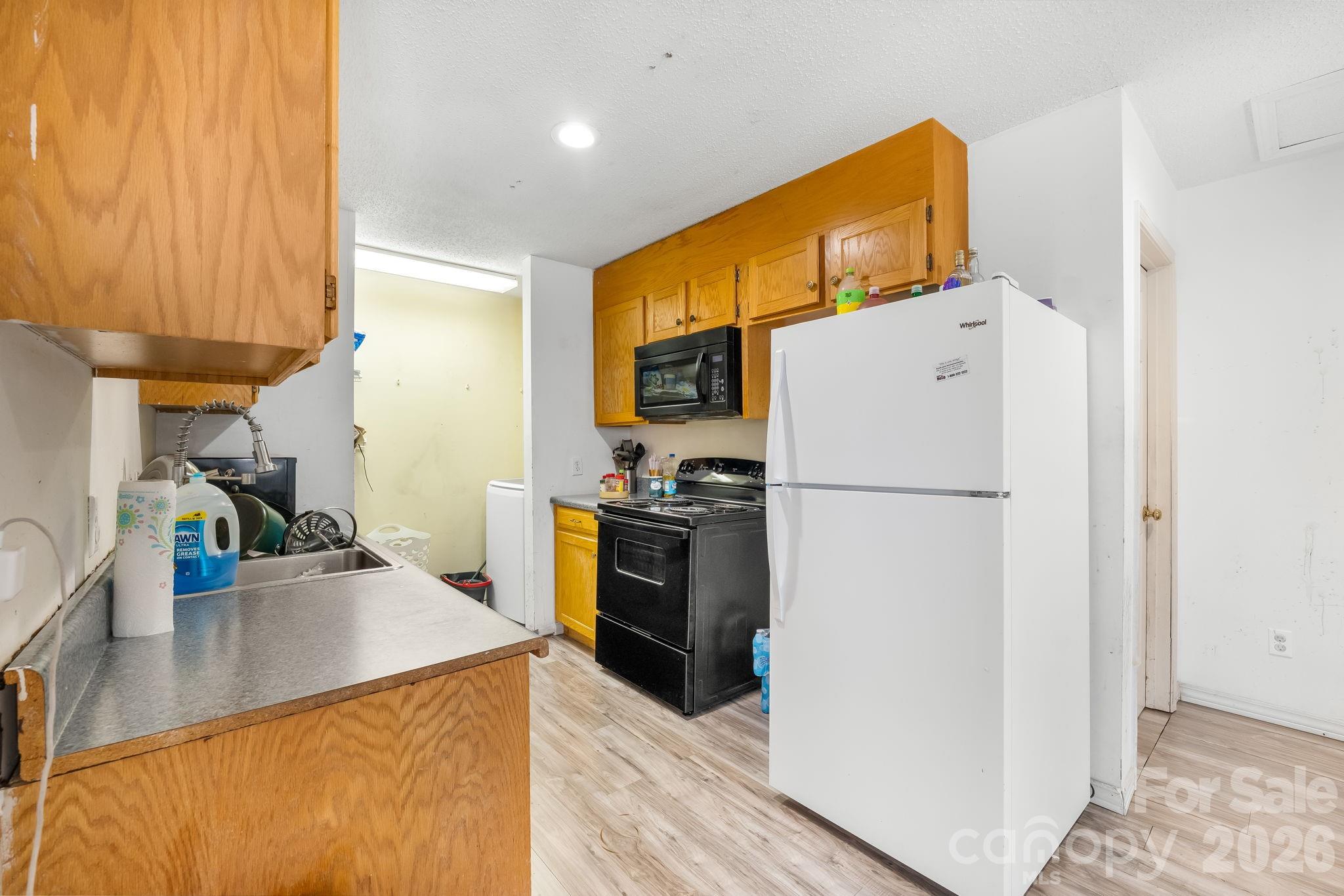 3761 Herman Sipe Road Conover, NC 28613 - Photo 15 of 27 a kitchen with a refrigerator a stove top oven a sink and dishwasher