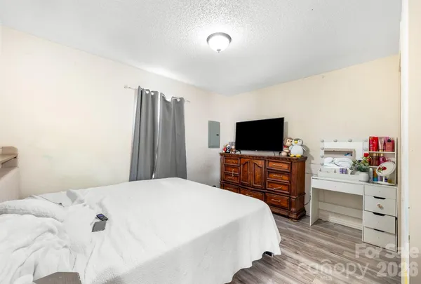a bedroom with a bed and flat screen tv