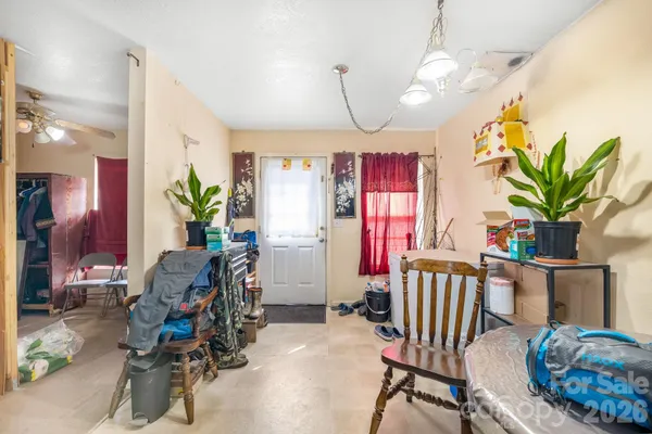 a view of a livingroom with furniture and bedroom
