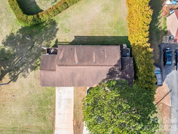 an aerial view of a house with a yard