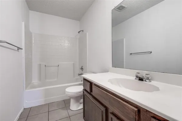 a bathroom with a sink toilet vanity and shower