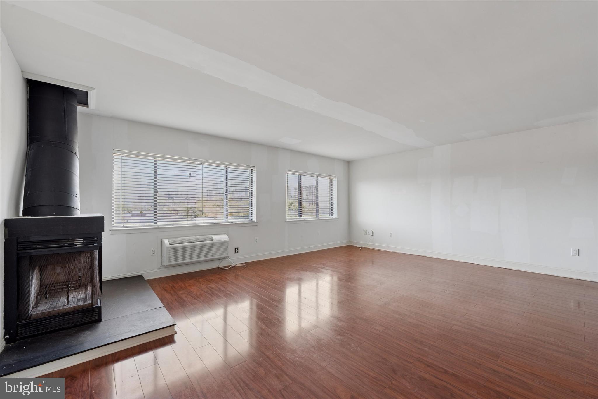 200 Lombard Street, Unit 804 Philadelphia, PA 19147 - Photo 8 of 15 an empty room with wooden floor and windows