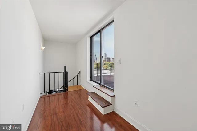 a view of hallway with wooden floor