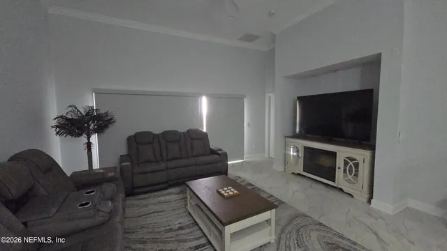 a living room with furniture and a flat screen tv