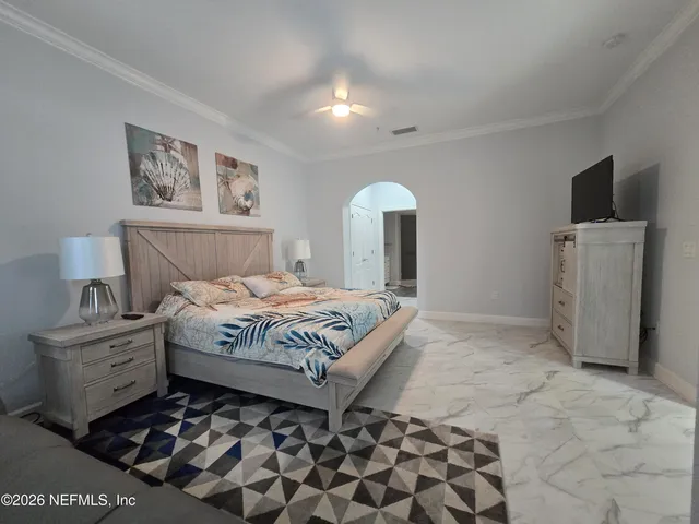 a bedroom with a bed and a television