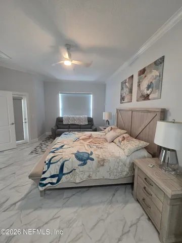 a bedroom with a bed and a painting on the wall