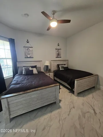 a bedroom with a bed and window