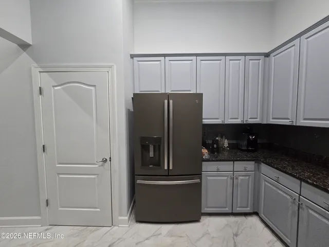 a kitchen with a refrigerator sink and cabinets