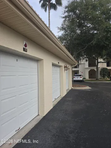 a view of a street with a garage