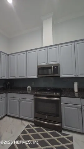 a kitchen with stainless steel appliances granite countertop a stove and a sink