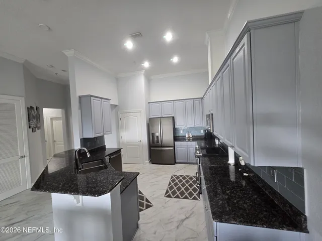 a kitchen with a refrigerator and a sink