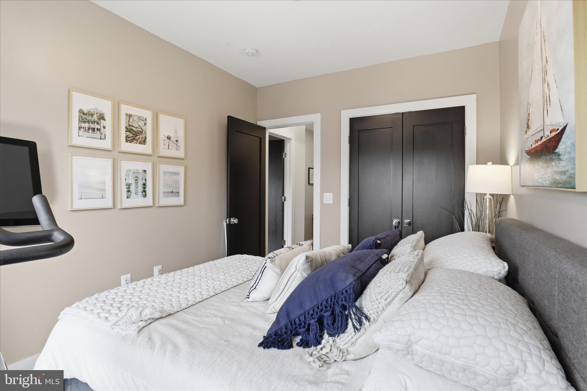 1222 Neal Street Northeast, Unit 3 Washington, DC 20002 - Photo 17 of 38 a bedroom with a bed and a painting on the wall