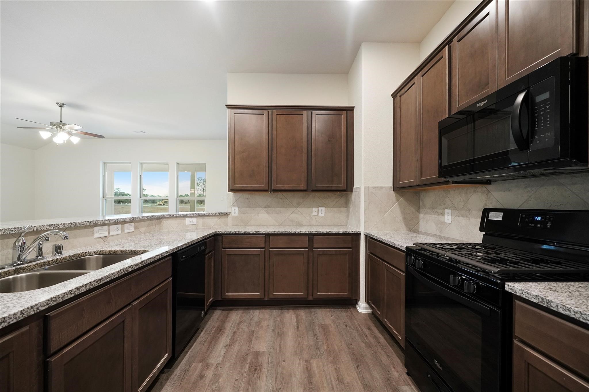 1435 Alice Drive Beaumont, TX 77705 - Photo 3 of 11 a kitchen with stainless steel appliances granite countertop a sink stove and microwave