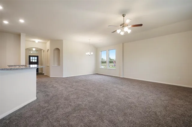 a view of a kitchen with a sink and a chandelier fan