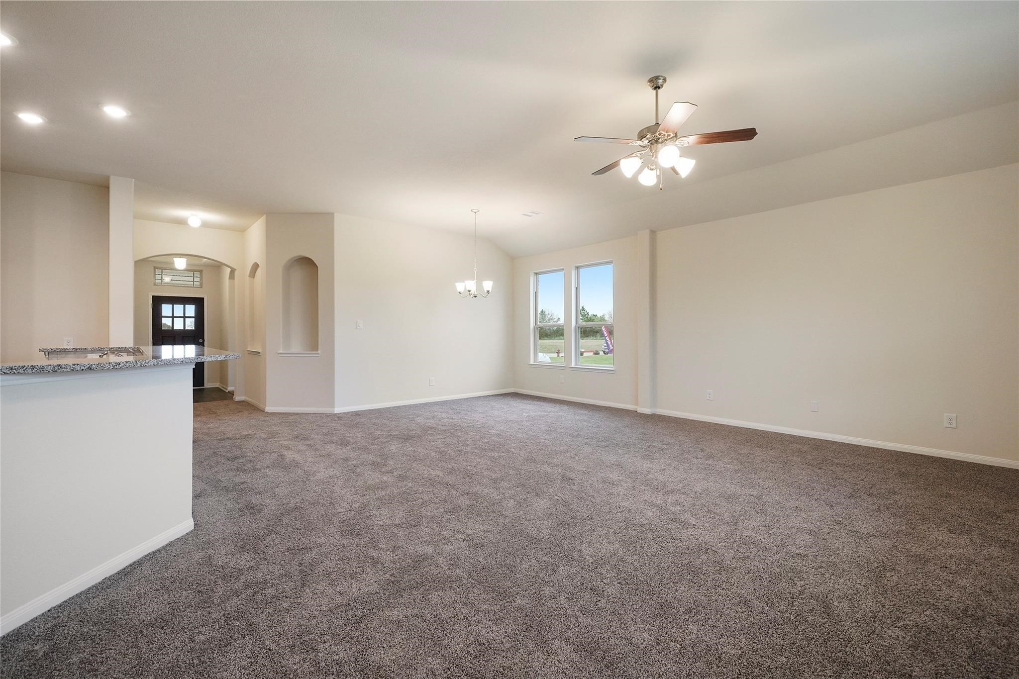 1435 Alice Drive Beaumont, TX 77705 - Photo 4 of 11 a view of a kitchen with a sink and a chandelier fan
