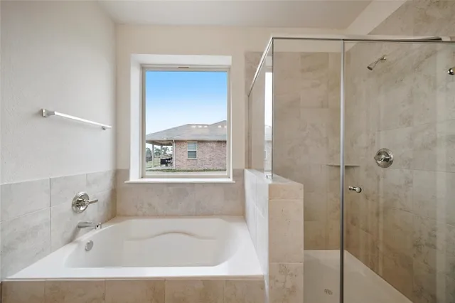 a white bath tub sitting next to a shower
