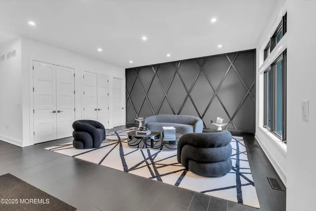 a living room with kitchen island furniture and a flat screen tv
