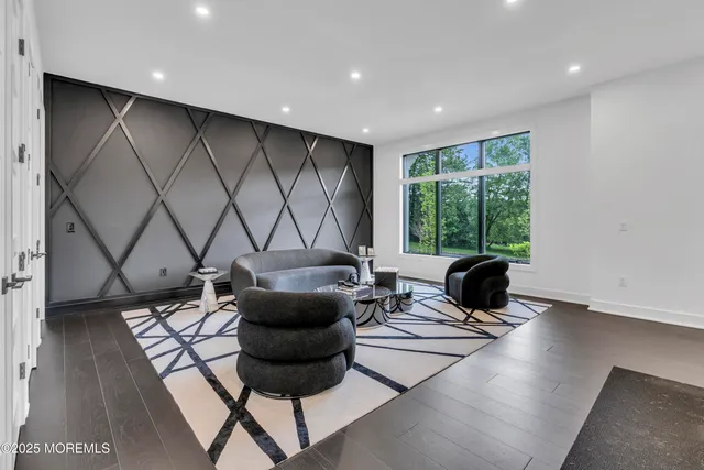 a bedroom with a bed and a flat tv screen on dresser