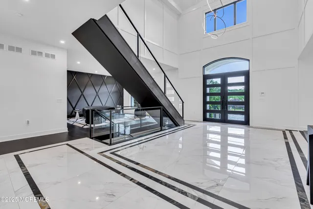 a living room with furniture a window and a chandelier