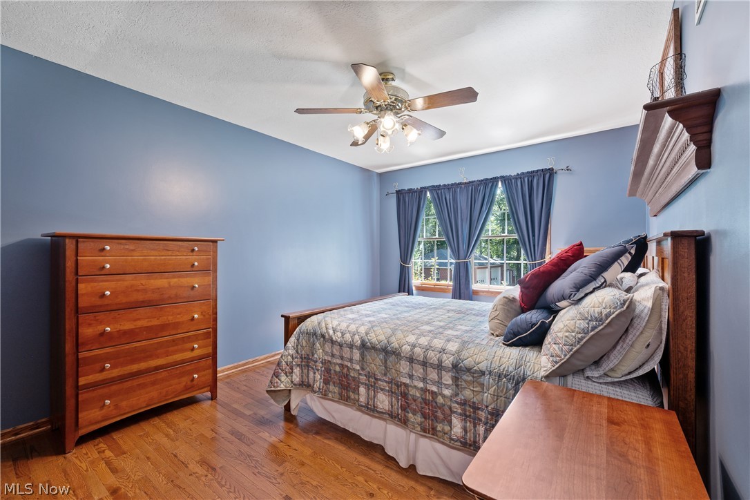 10400 Stoneacre Road Northwest Canal Fulton, OH 44614 - Photo 19 of 44 Bedroom featuring wood finished floors and ceiling fan