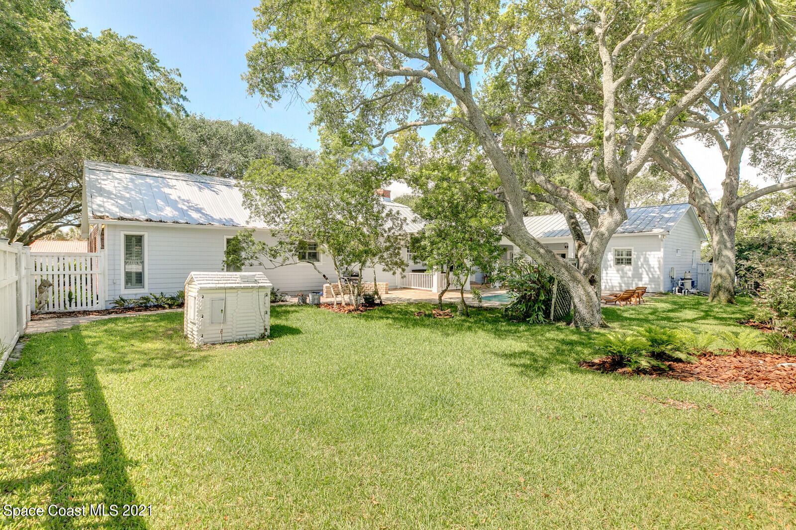 200 Melbourne Avenue Indialantic, FL 32903 - Photo 13 of 62 a white house that has a tree in front of it