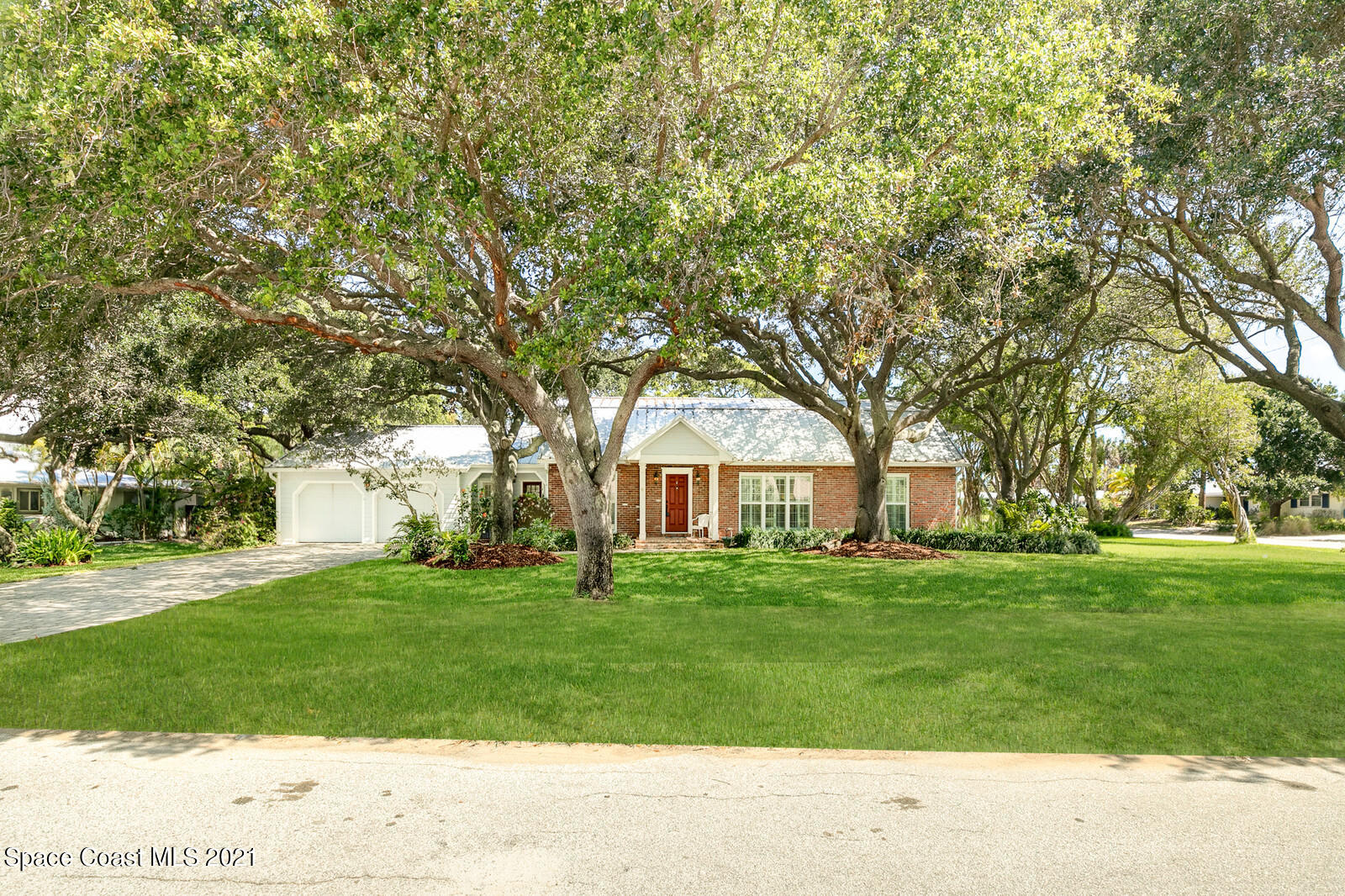 200 Melbourne Avenue Indialantic, FL 32903 - Photo 3 of 62 a front view of a house with a garden