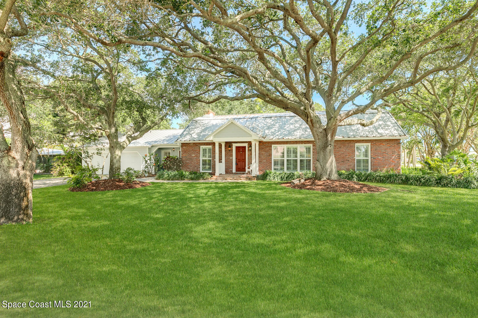 200 Melbourne Avenue Indialantic, FL 32903 - Photo 4 of 62 a front view of a house with yard and green space