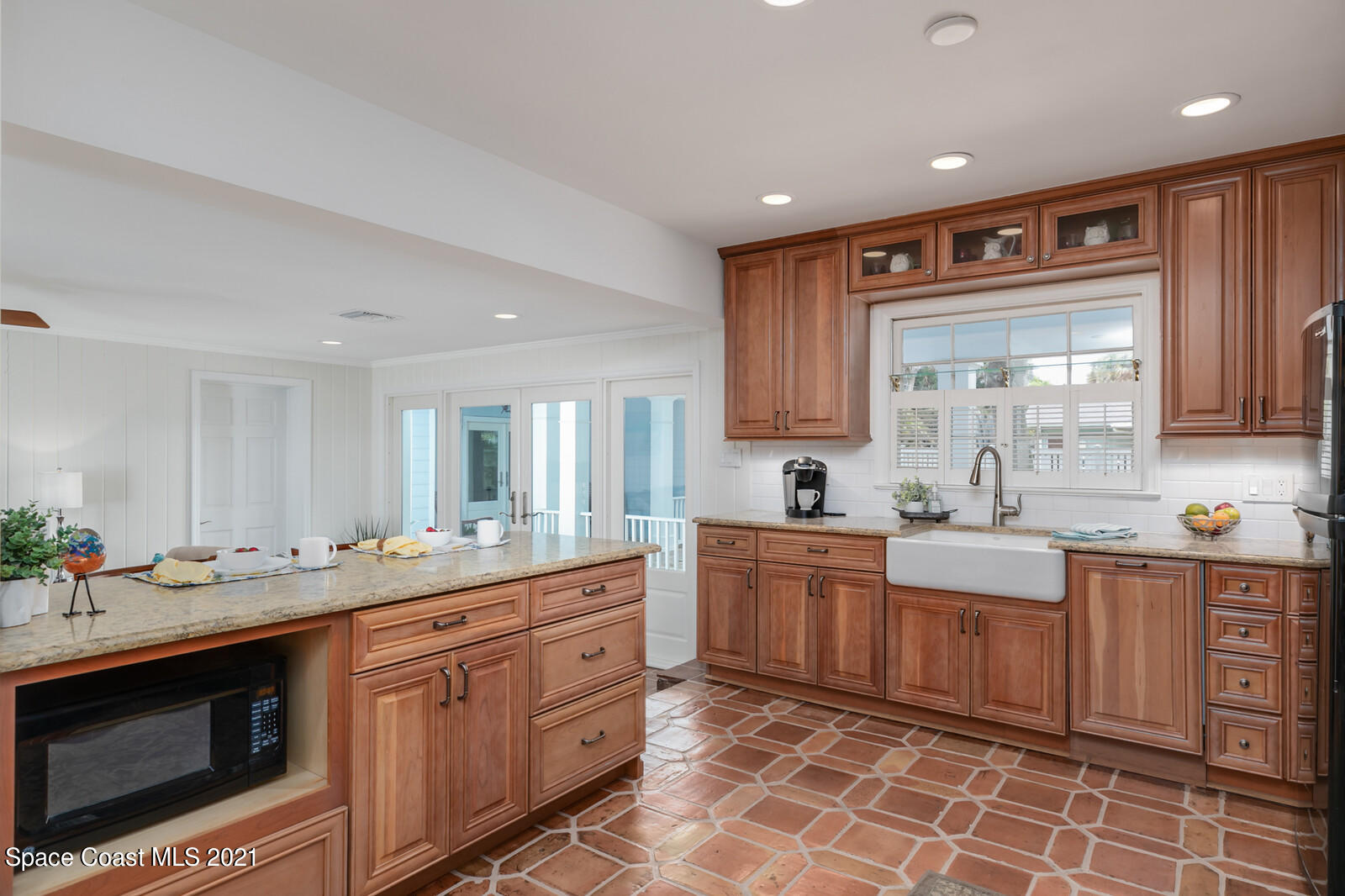200 Melbourne Avenue Indialantic, FL 32903 - Photo 34 of 62 a large kitchen with stainless steel appliances a stove sink and cabinets