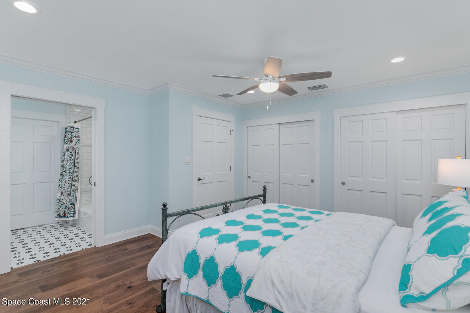 200 Melbourne Avenue Indialantic, FL 32903 - Photo 45 of 62 a bedroom with a bed and a table with wooden floor