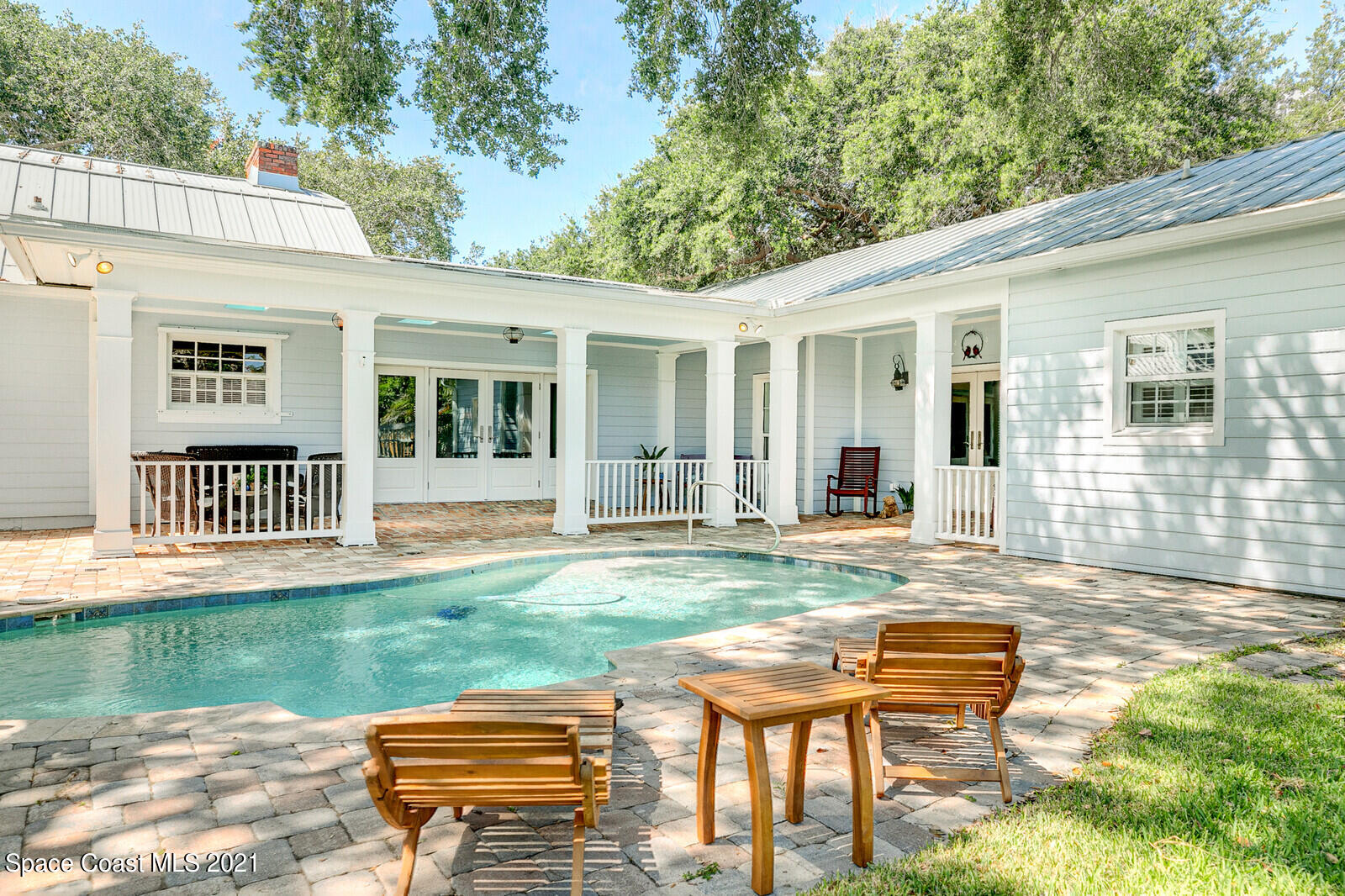 200 Melbourne Avenue Indialantic, FL 32903 - Photo 8 of 62 a backyard of a house with table and chairs